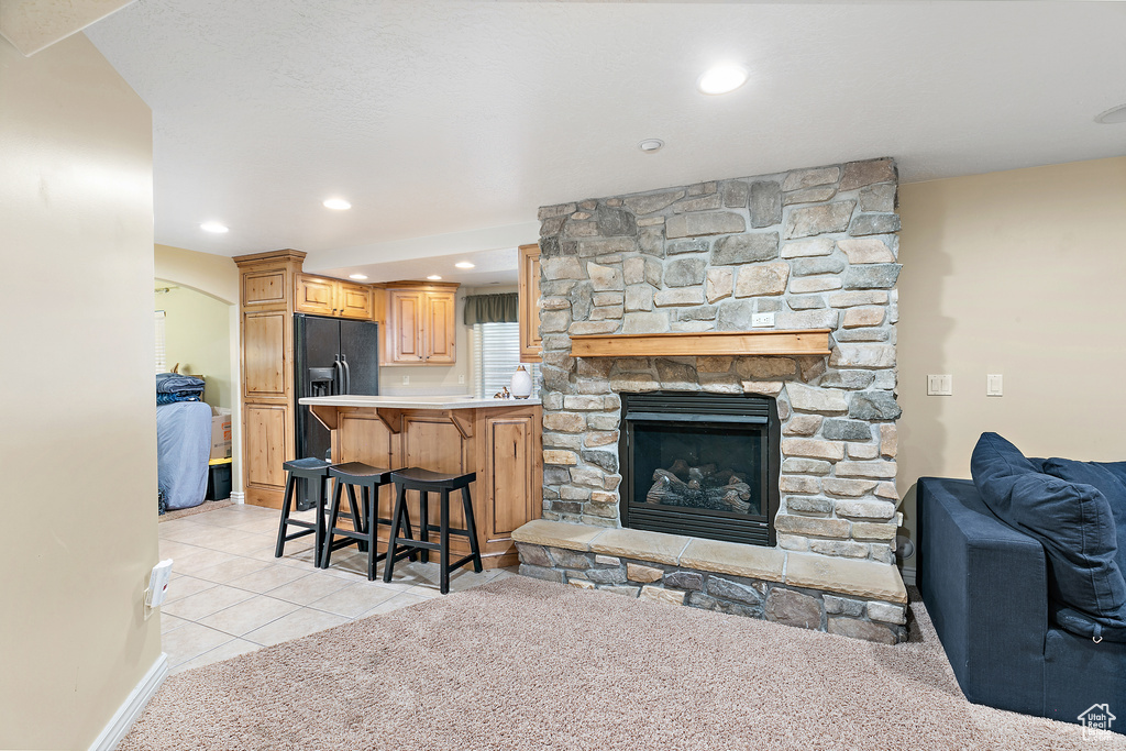 Living area featuring light tile patterned floors, a fireplace, and recessed lighting