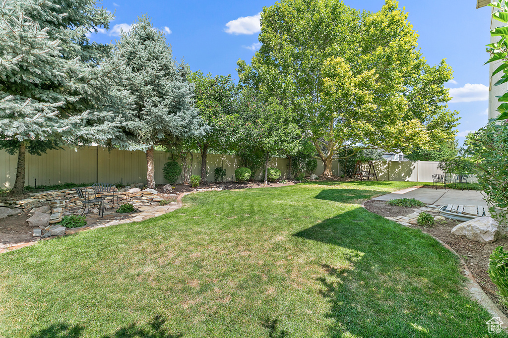 View of yard with a patio area and a fenced backyard