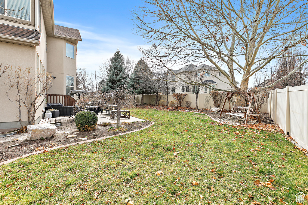 View of yard with a fenced backyard and a patio area