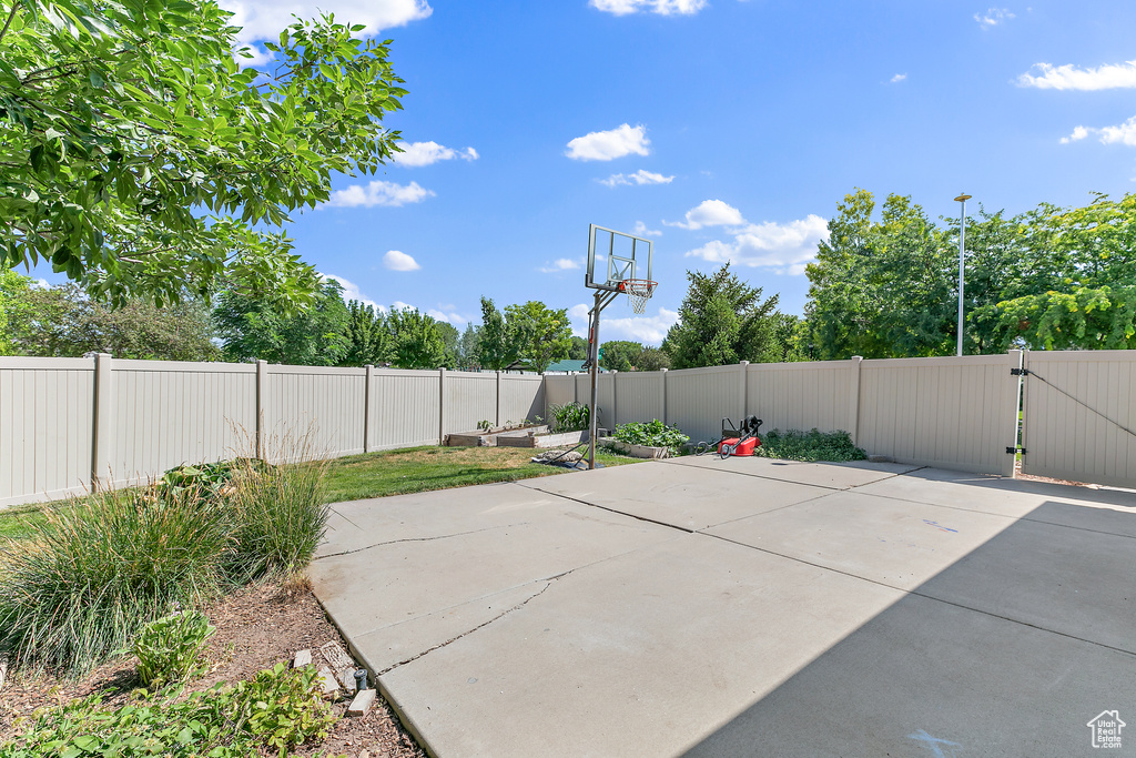 Exterior space featuring a gate and a fenced backyard