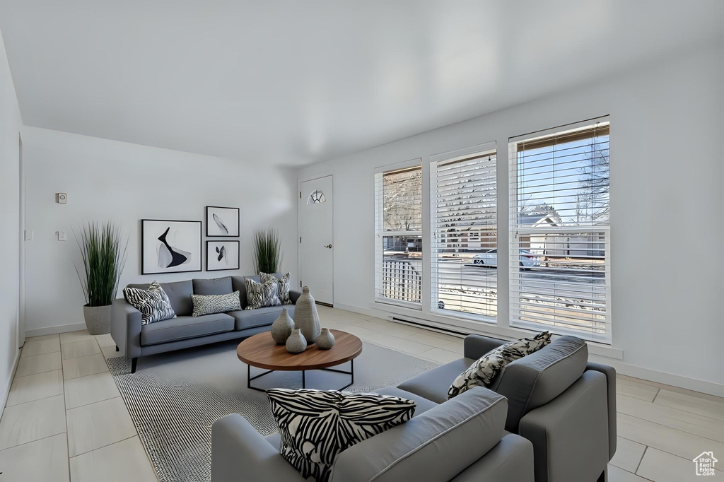 Living room featuring light tile patterned floors and baseboards