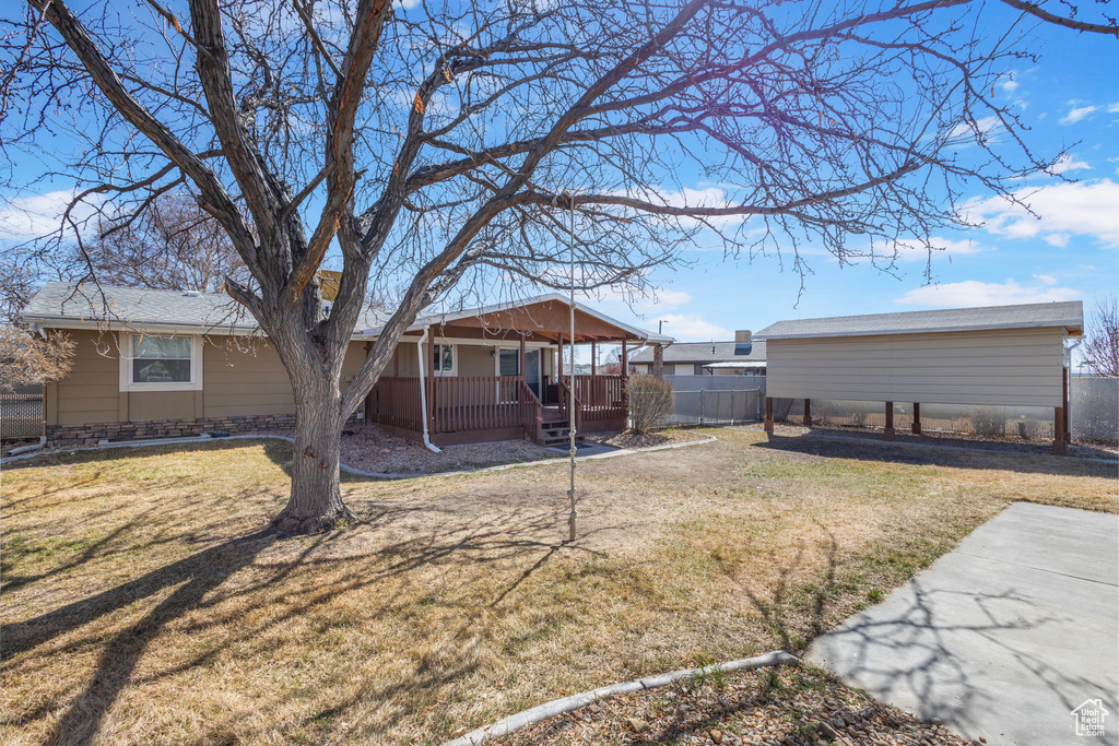 View of yard with fence and covered porch