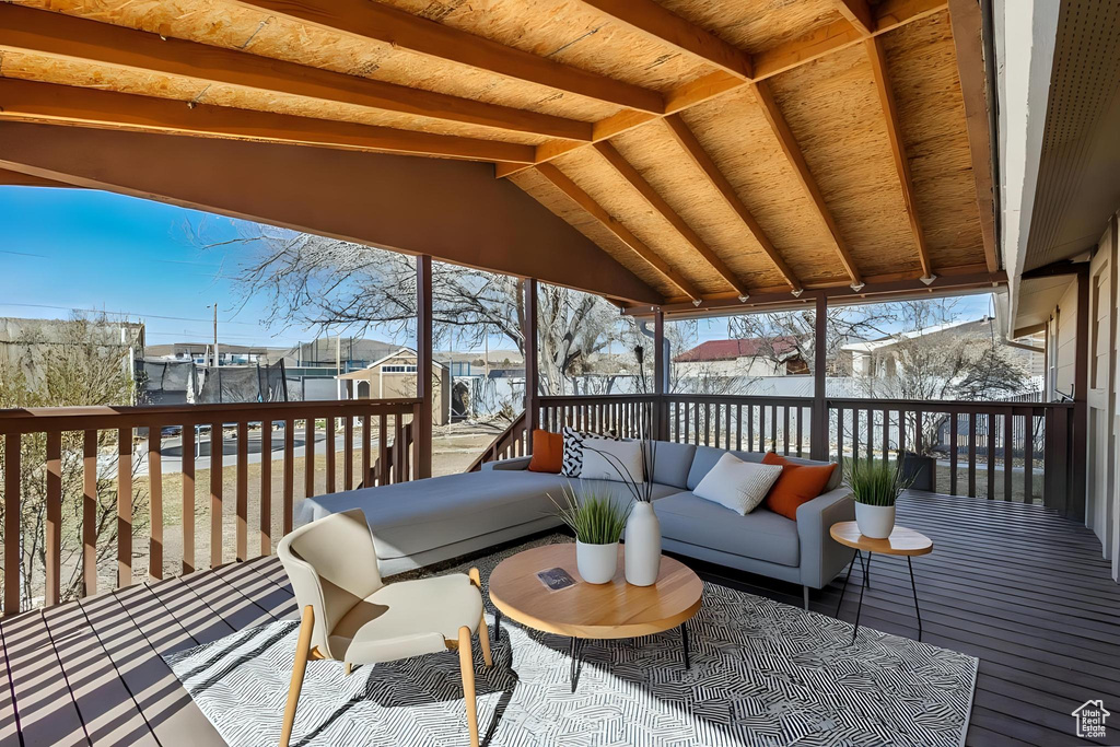 Wooden terrace featuring an outdoor hangout area and fence