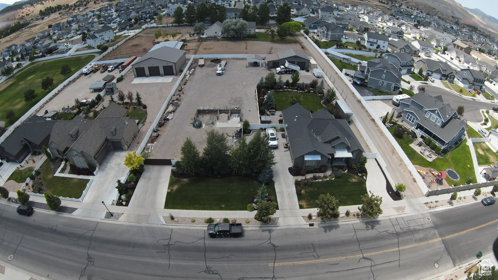 Aerial view of property's location with nearby suburban area and mountains