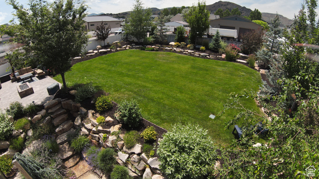 Fenced backyard featuring a residential view and a mountain view