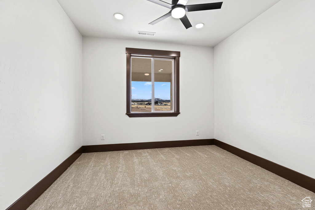 Carpeted empty room featuring recessed lighting, visible vents, ceiling fan, and baseboards