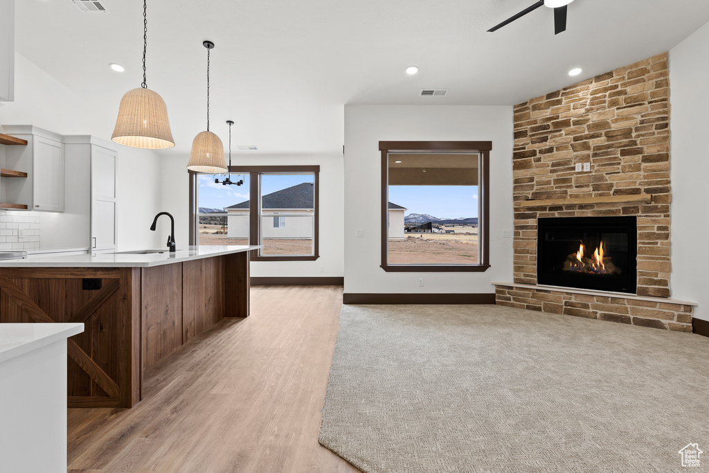 Kitchen with visible vents, open shelves, tasteful backsplash, light countertops, and hanging light fixtures