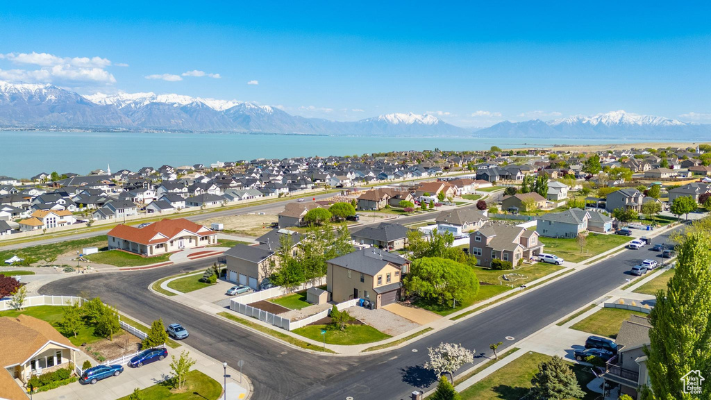 Birds eye view of property with a water and mountain view and a residential view