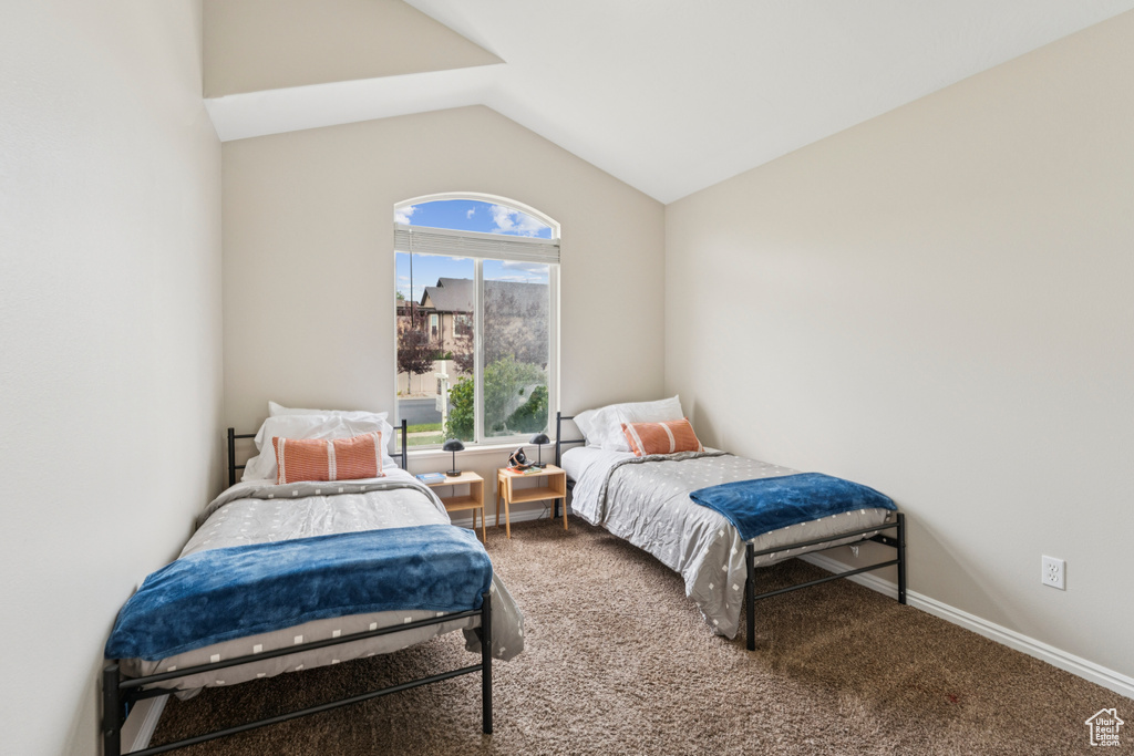 Carpeted bedroom with vaulted ceiling
