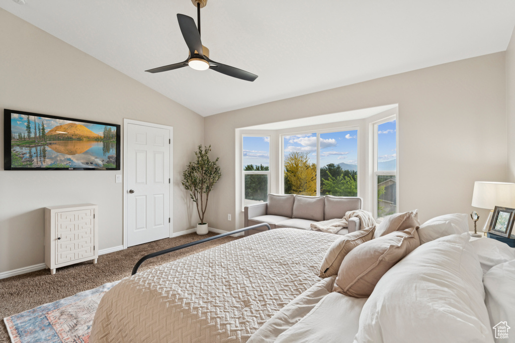 Carpeted bedroom with lofted ceiling and ceiling fan