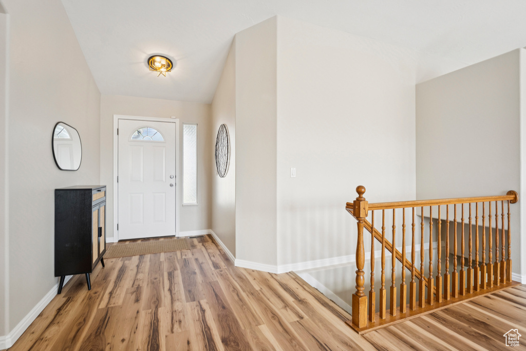 Entryway with baseboards and wood finished floors