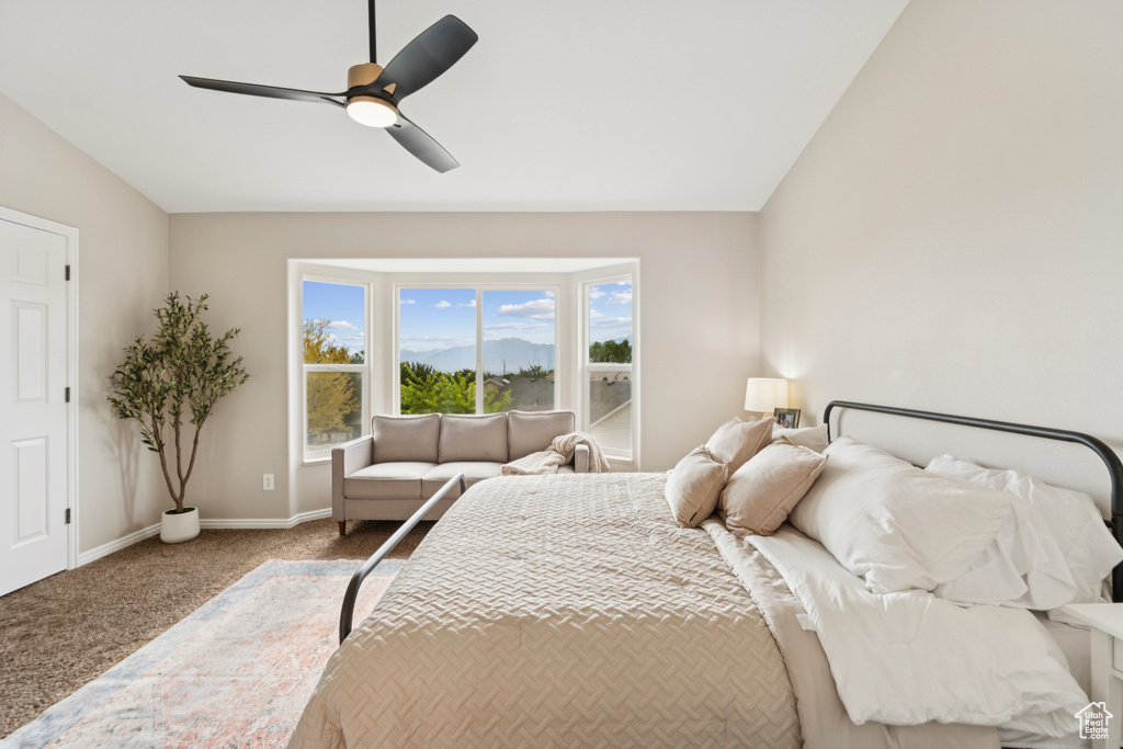 Bedroom featuring carpet flooring, lofted ceiling, and a ceiling fan