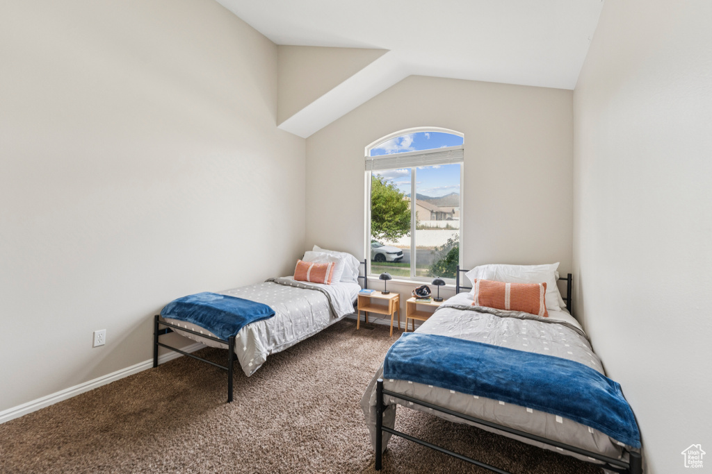Bedroom with carpet and lofted ceiling