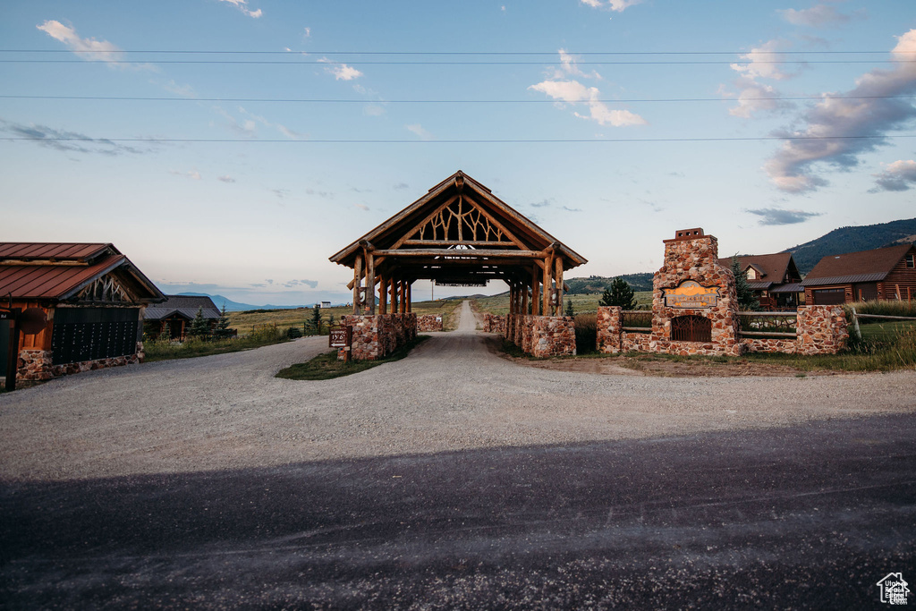 Exterior space with a gazebo, a mountain view, and driveway