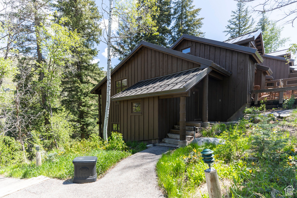View of front of home with board and batten siding, a standing seam roof, and metal roof