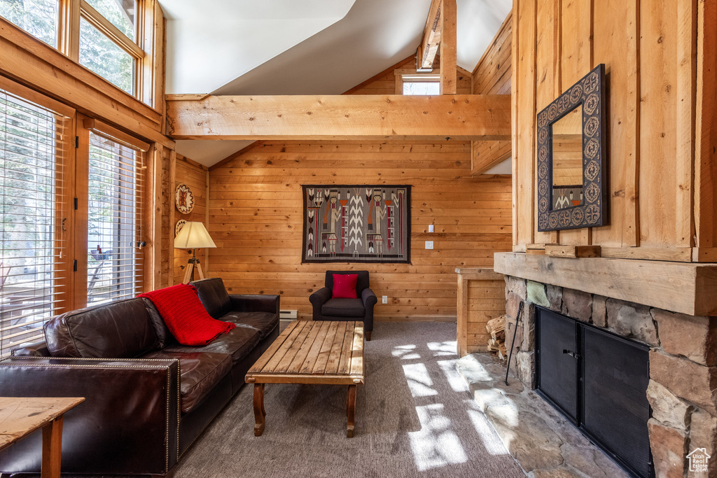 Living room with wooden walls, carpet, a fireplace, high vaulted ceiling, and a baseboard heating unit