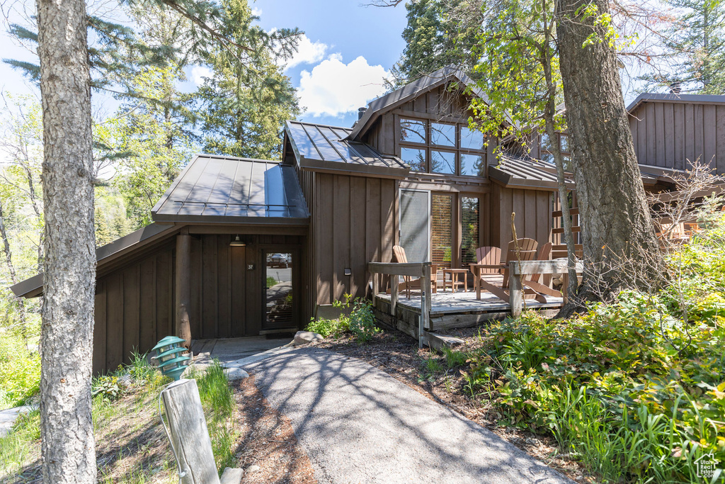 View of front of home with board and batten siding and a deck