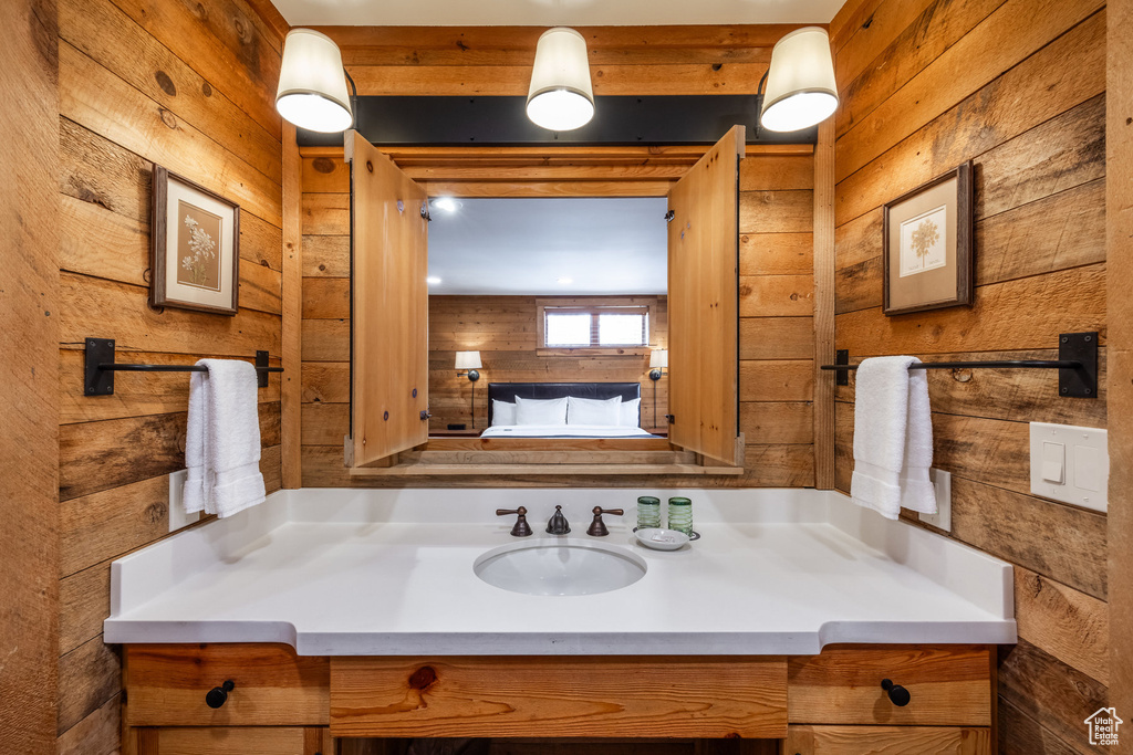Bathroom with wood walls and vanity