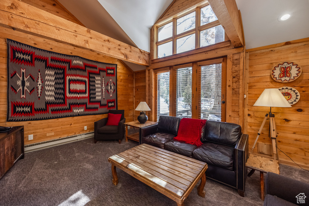 Living area with wood walls, lofted ceiling, and carpet flooring
