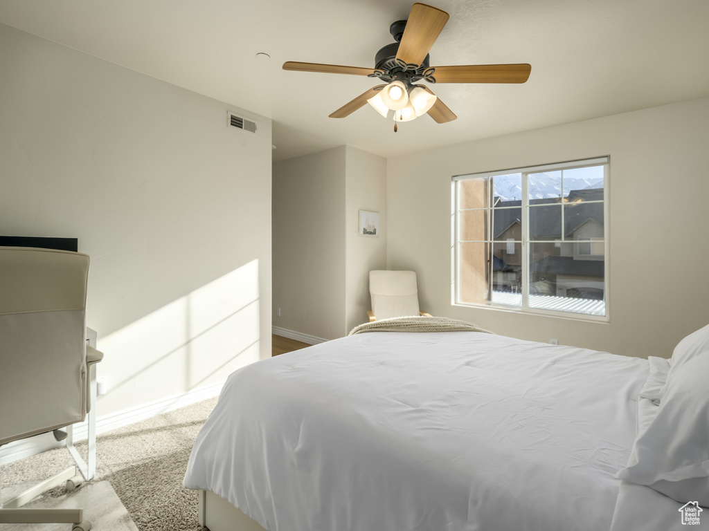 Bedroom with visible vents, baseboards, and ceiling fan