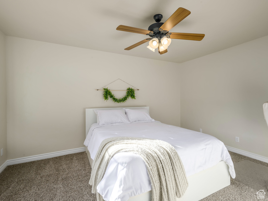 Bedroom featuring carpet, baseboards, and ceiling fan