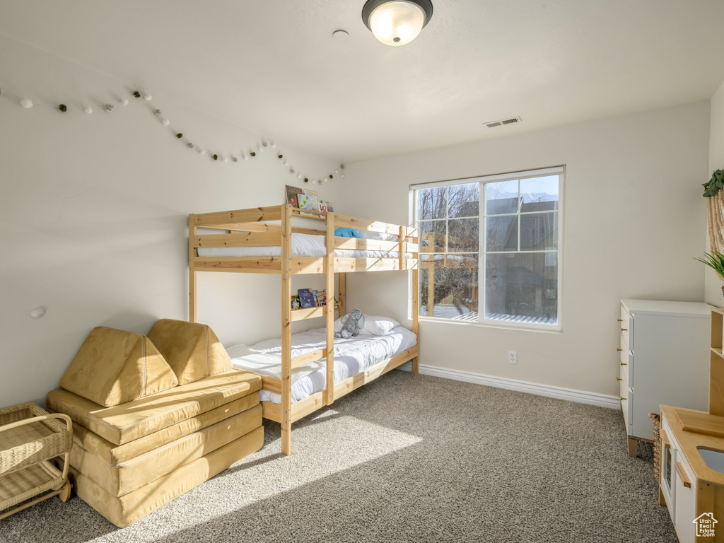 Bedroom with visible vents, baseboards, and carpet flooring