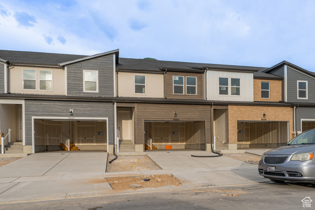 View of property with a garage and driveway