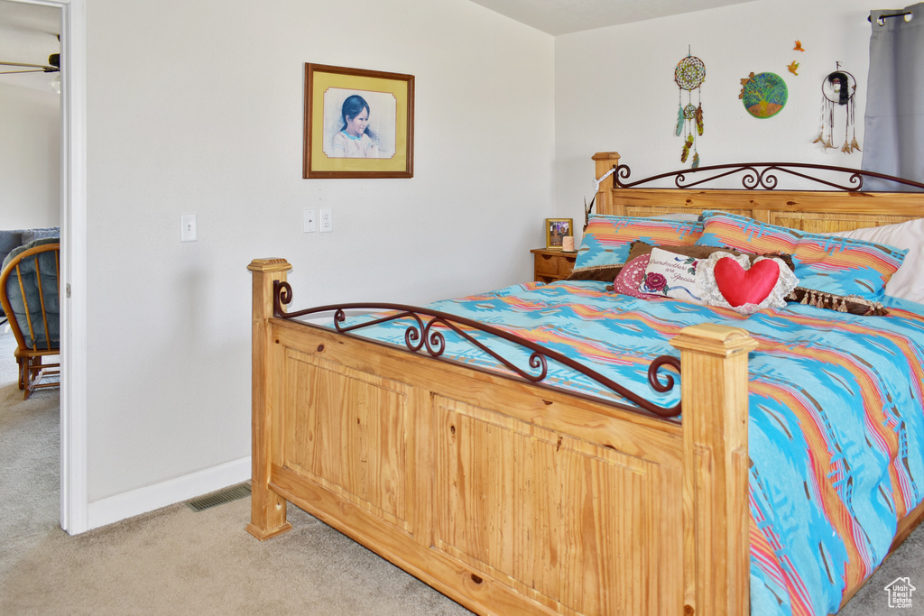 Carpeted bedroom featuring visible vents and baseboards