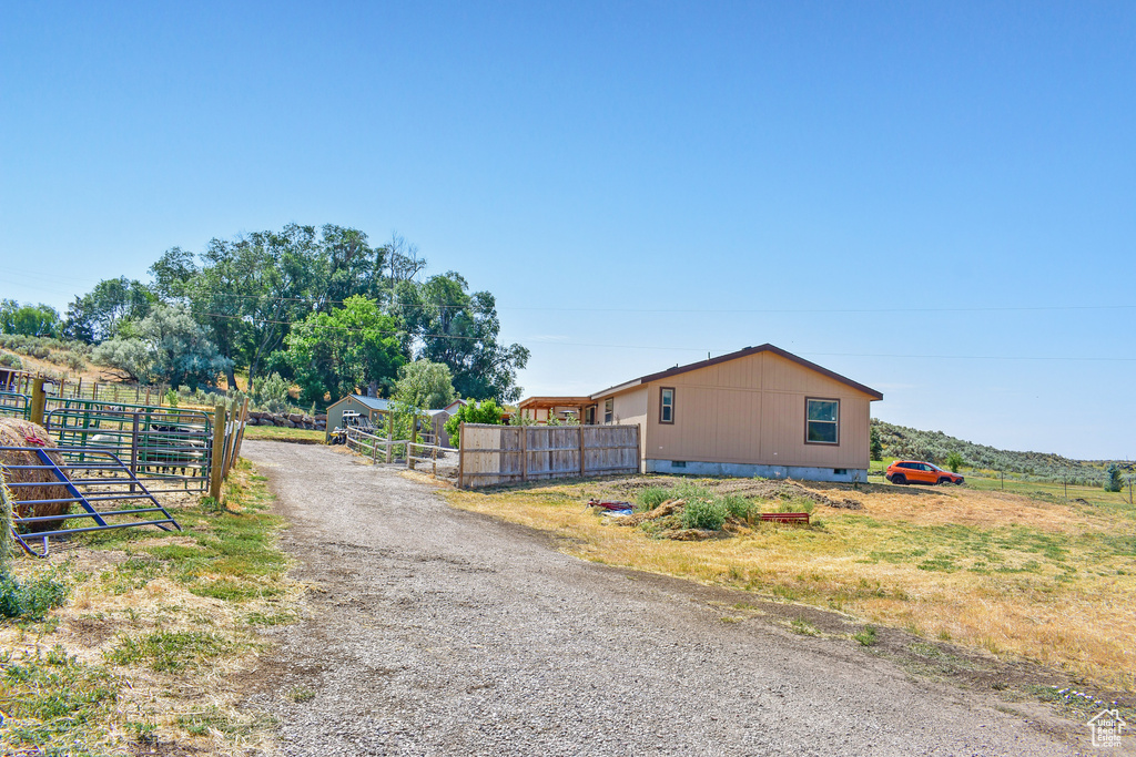View of road with a gated entry, driveway, and a gate