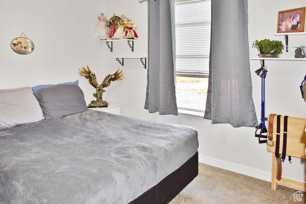 Carpeted bedroom featuring baseboards