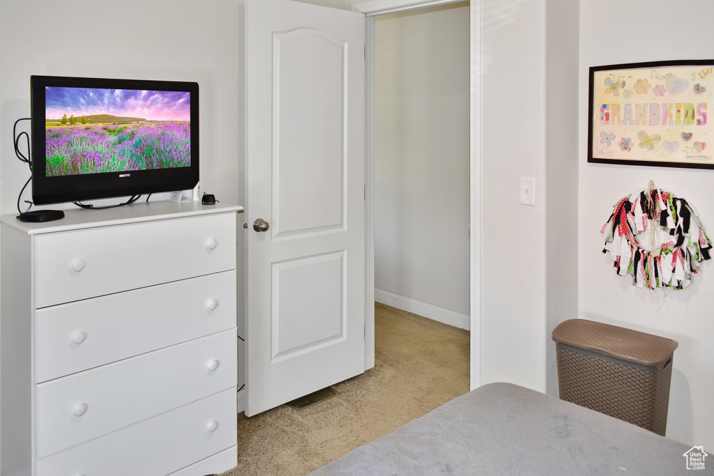 Bedroom featuring light colored carpet and baseboards