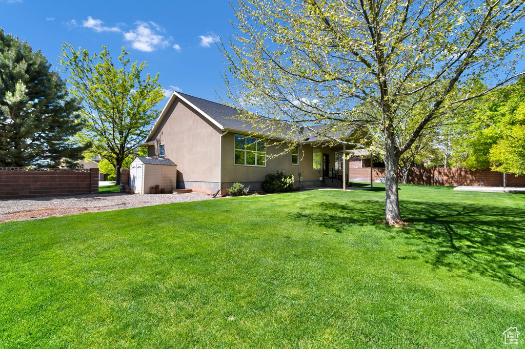 Single story home with a shed, an outdoor structure, and stucco siding