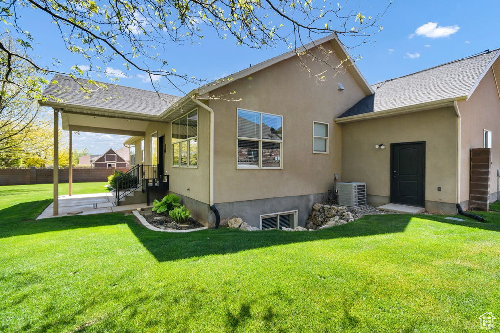 Rear view of property with central AC, stucco siding, and a patio