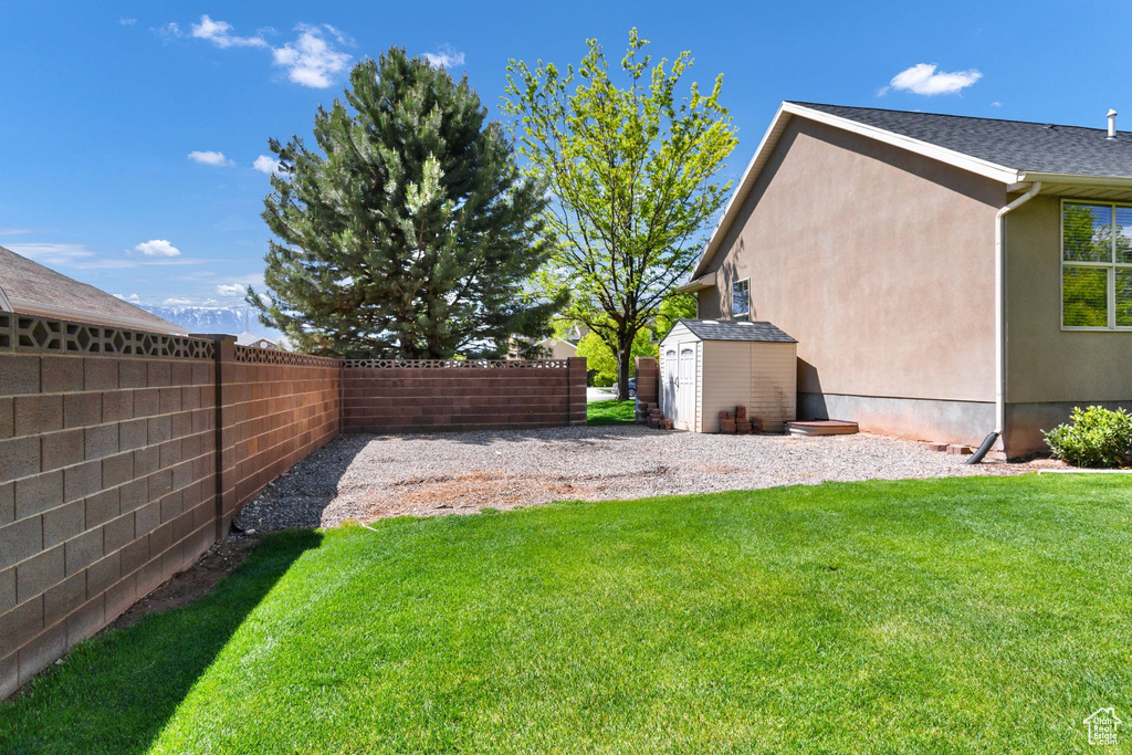 View of yard with a storage shed and an outdoor structure