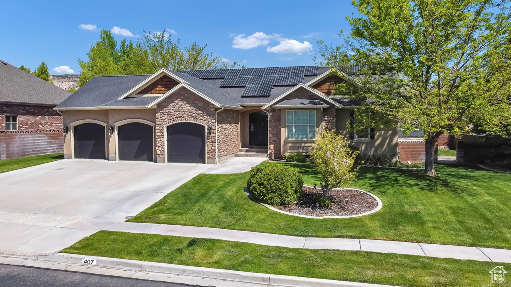 Craftsman-style house with stone siding, roof mounted solar panels, an attached garage, and concrete driveway