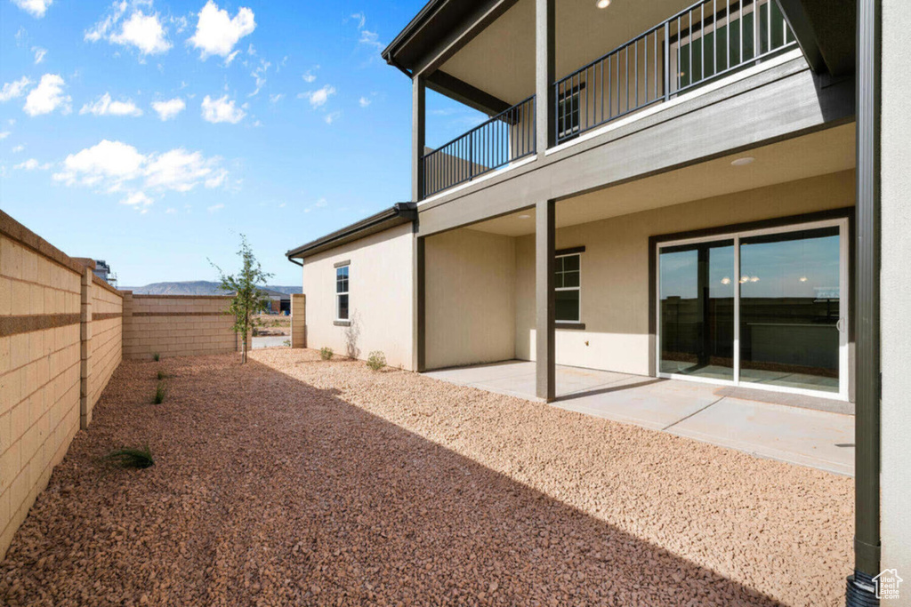 View of yard with a balcony, a patio, and a fenced backyard
