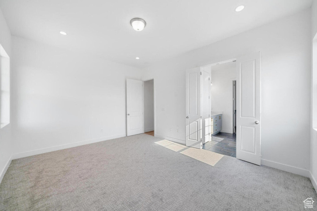 Unfurnished bedroom with carpet flooring, recessed lighting, and baseboards