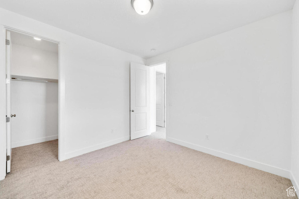 Unfurnished bedroom with a closet, baseboards, and carpet floors