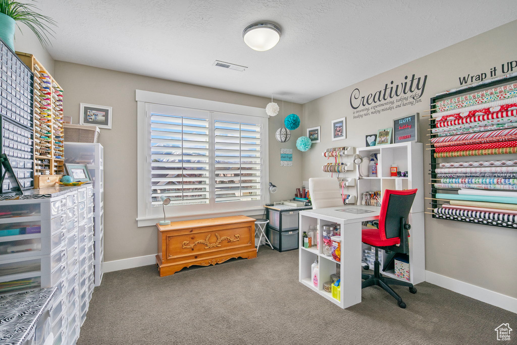 Office space featuring visible vents, carpet flooring, a textured ceiling, and baseboards
