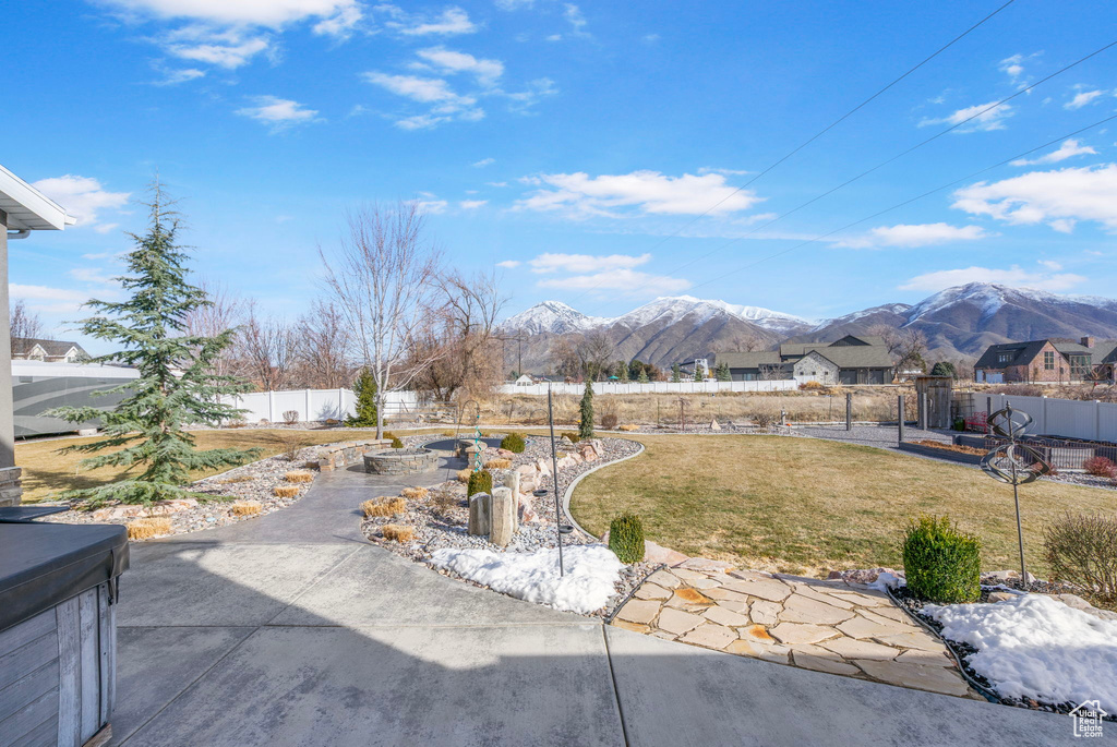 View of yard with a mountain view, a fenced backyard, and a patio