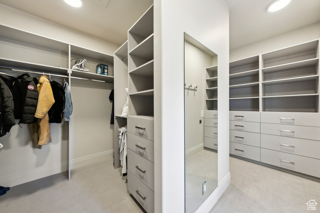 Walk in closet featuring light carpet