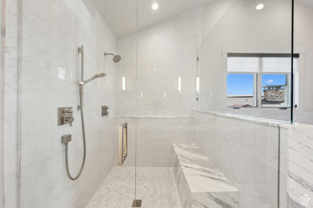 Bathroom with vaulted ceiling, a stall shower, and recessed lighting