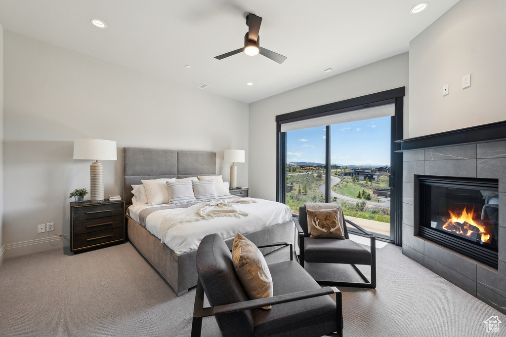 Carpeted bedroom with access to outside, recessed lighting, ceiling fan, and a fireplace