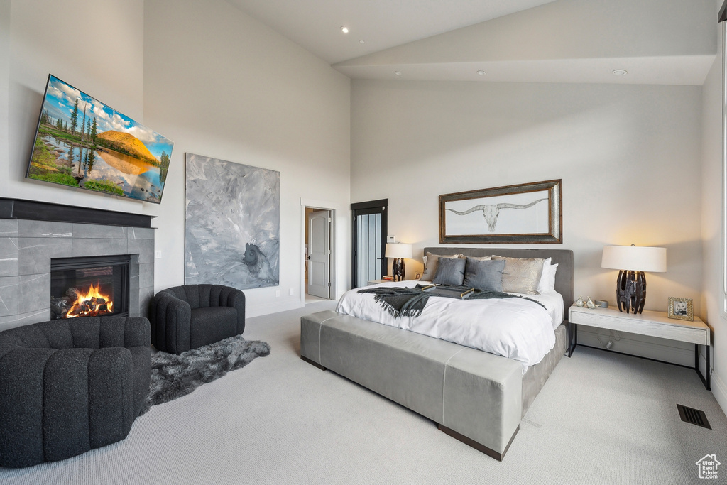 Bedroom featuring visible vents, a tile fireplace, carpet floors, high vaulted ceiling, and recessed lighting