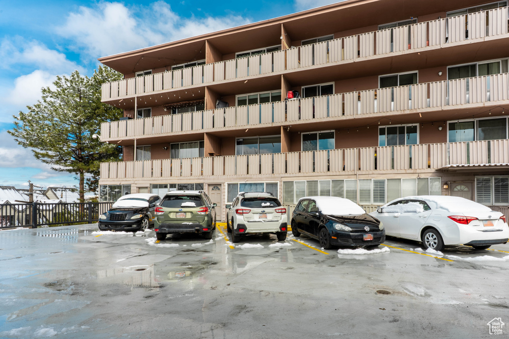 View of building exterior with uncovered parking