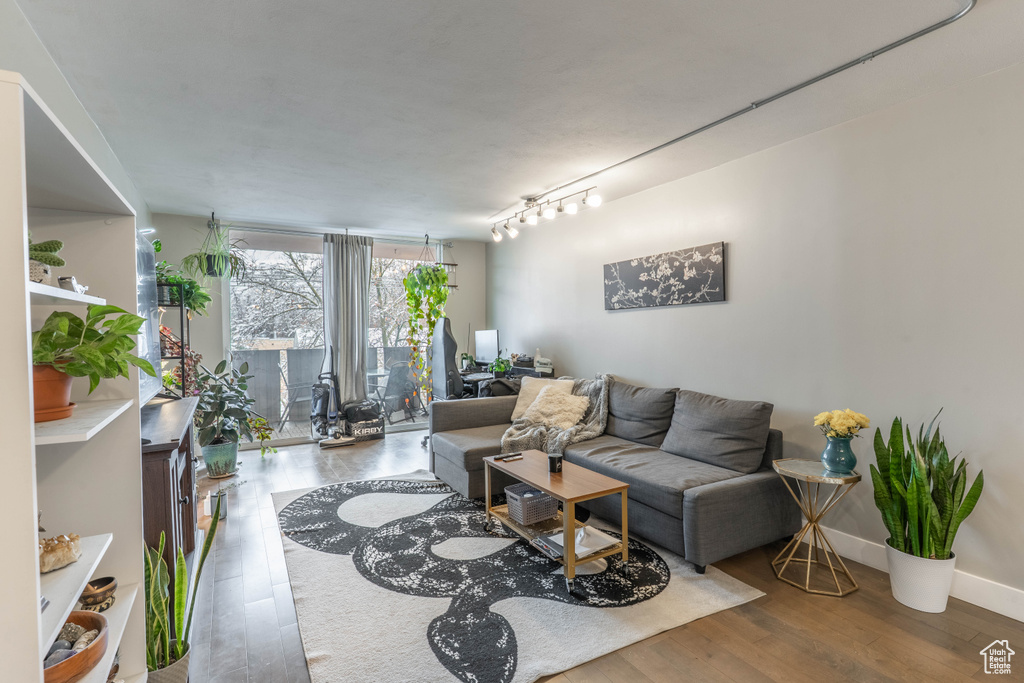 Living area with baseboards and wood finished floors