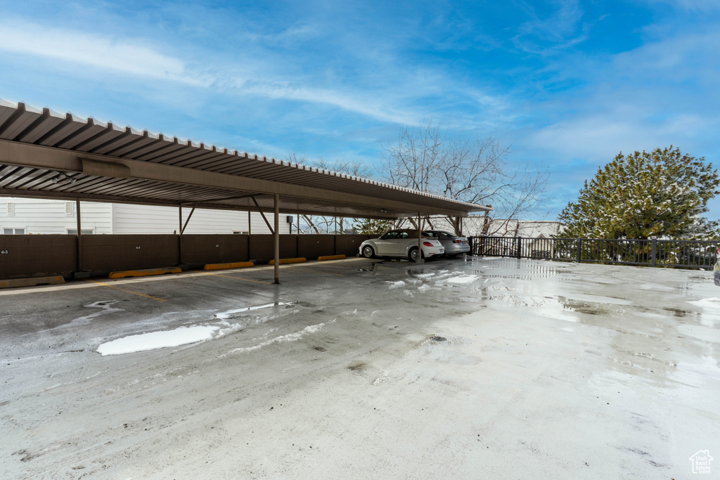 Covered parking lot featuring fence
