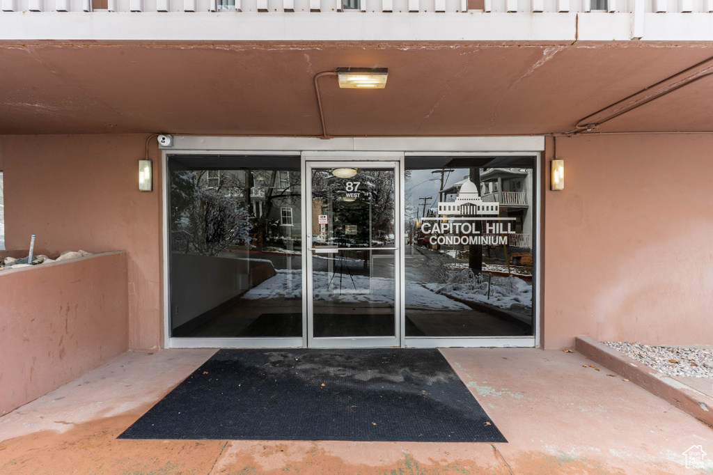 View of exterior entry with stucco siding
