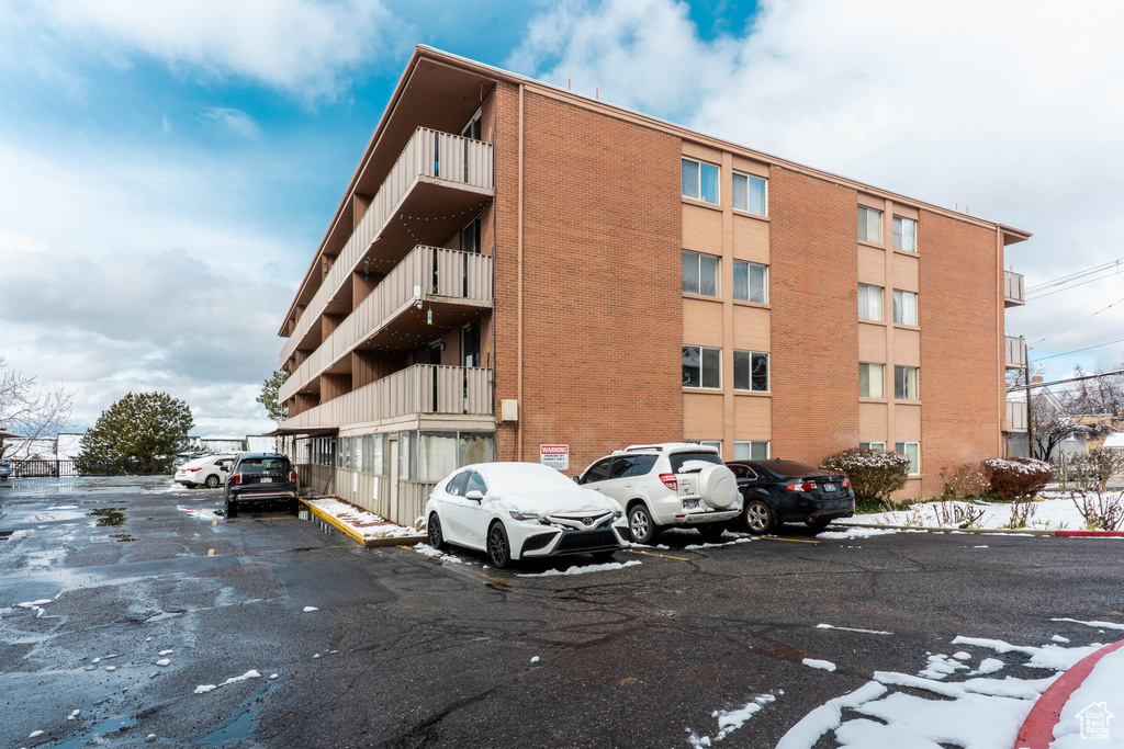 View of property featuring uncovered parking
