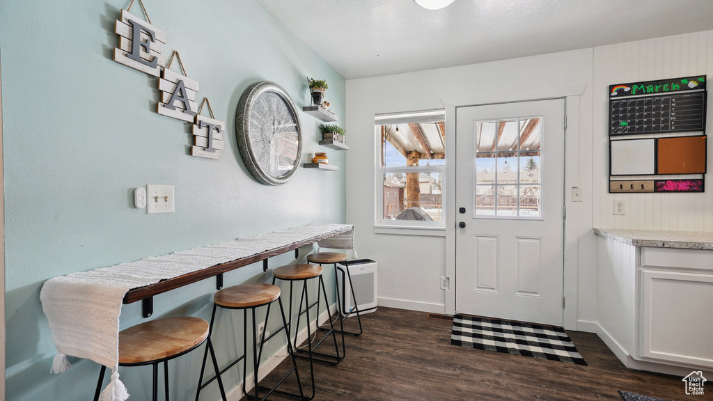 Interior space featuring dark wood-style floors and baseboards